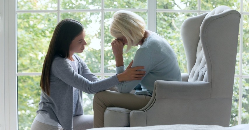 A young woman comforting an older woman