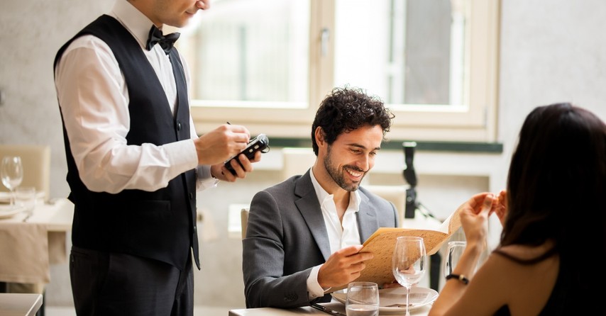 Man ordering dinner at a fancy restaurant