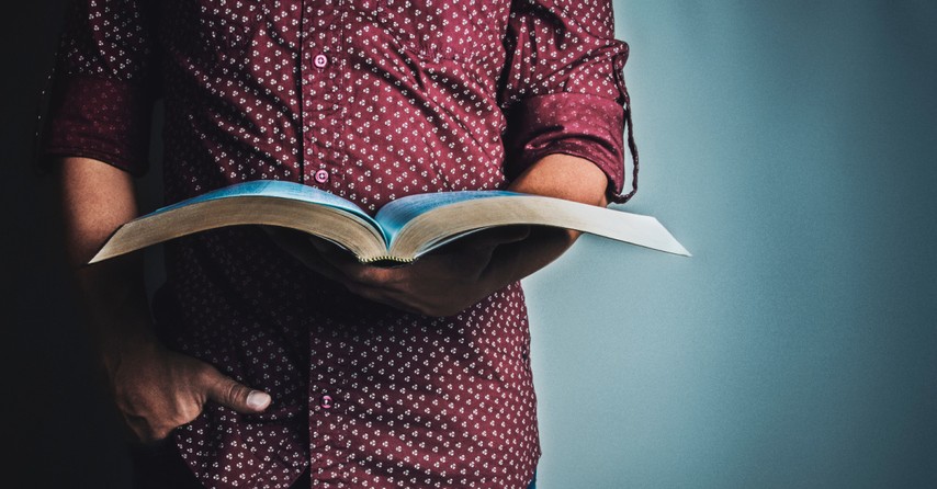 a man holding a Bible