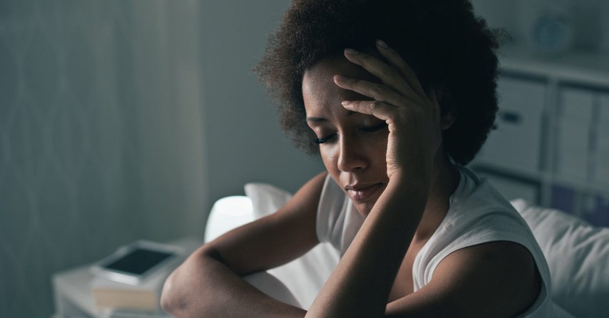 Woman with her hand on her head, depressed