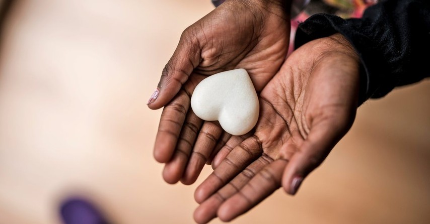 Hands holding a white heart