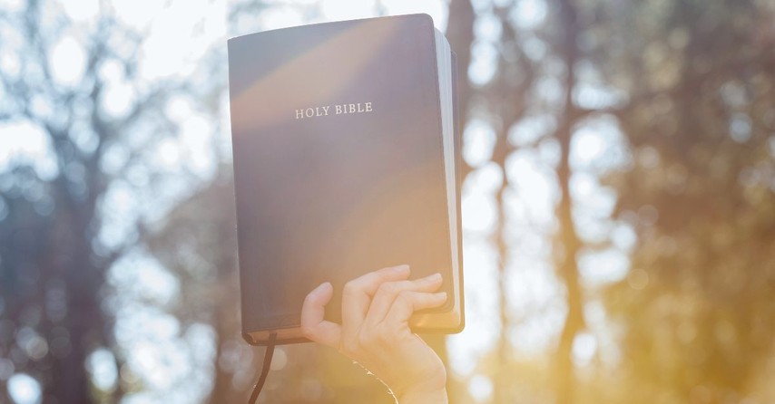 Bible held in the air