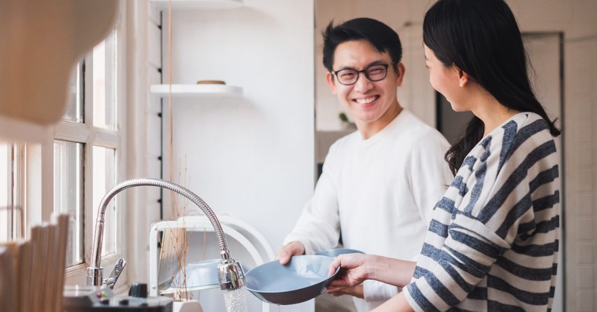 Married couple washing dishes together