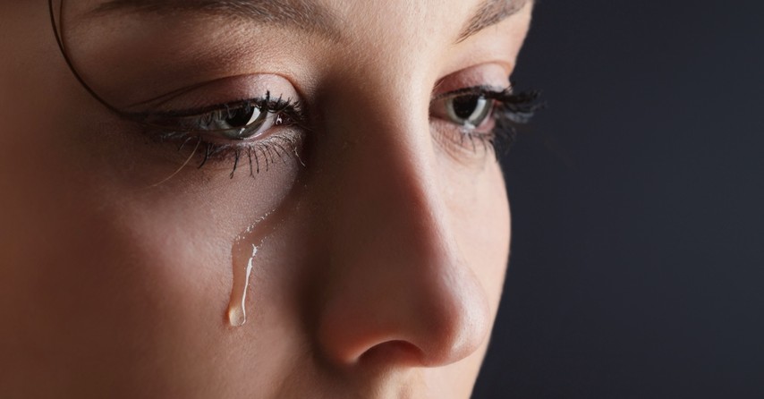 Woman with a single tear running down her face