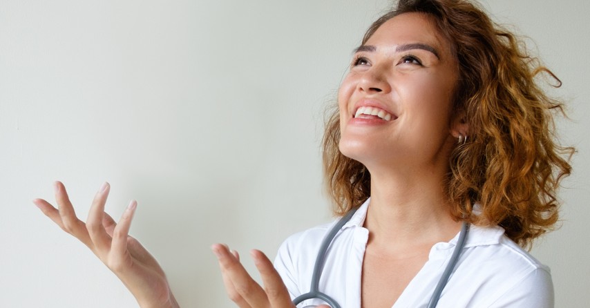 woman doctor praising that God answers prayer