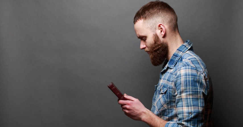 Man holding a Bible and praying