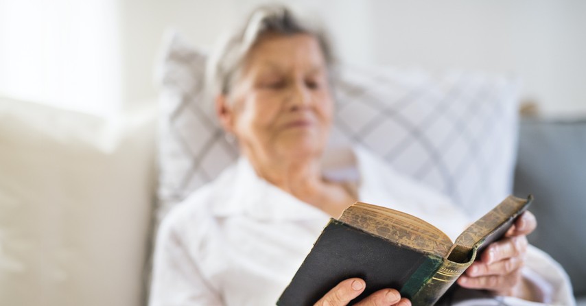 Elderly woman reading the Bible