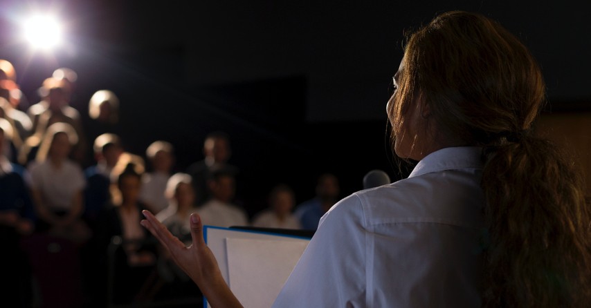 Woman giving a speech before a crowd