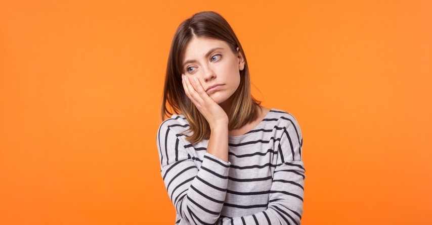 disappointed woman holding her head