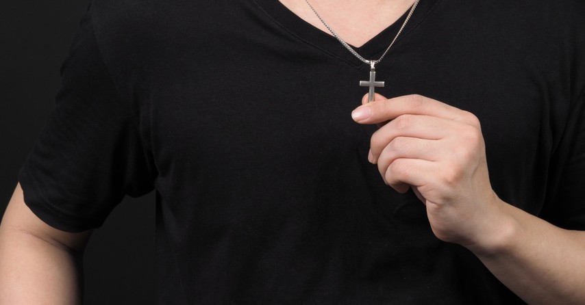 Man wearing a silver cross necklace