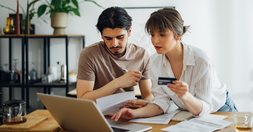 married couple managing finances money credit card paying