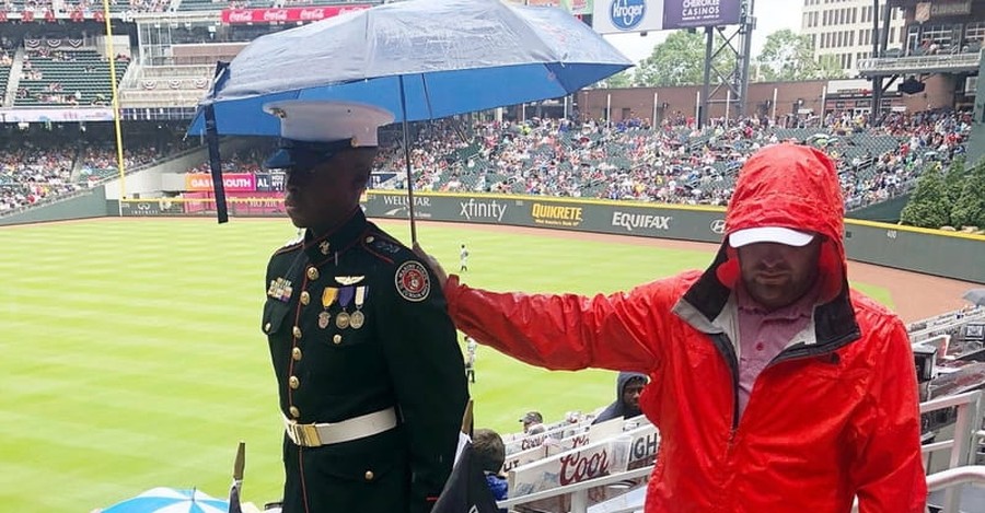 Moving Photo Shows Atlanta Braves Fan Shielding JROTC Member from Rain