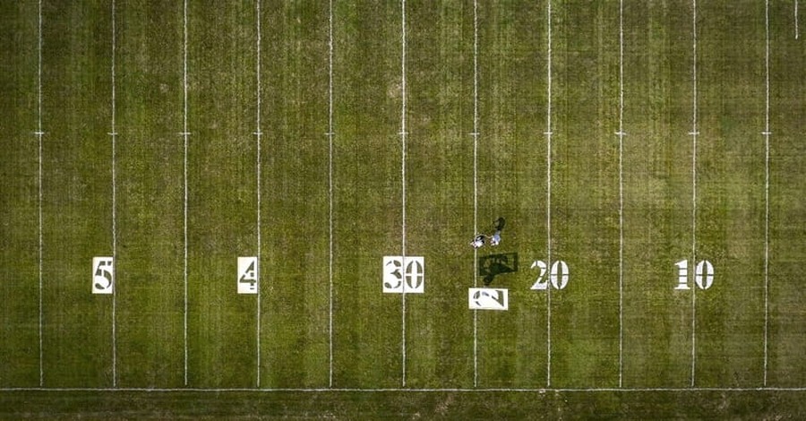 High School Paints over the Name of Christ in Football Field Logo 