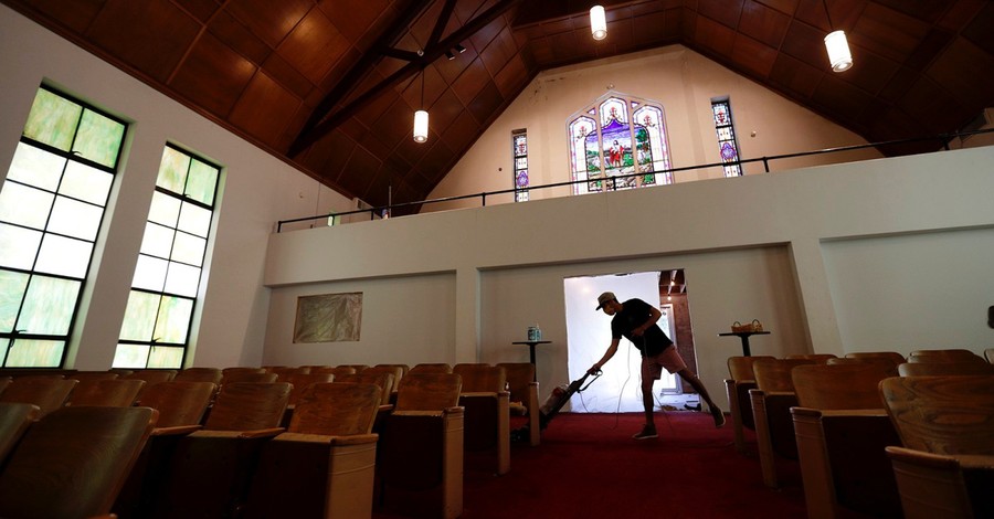 someone vacuuming a church sanctuary, Churches and insurance companies grapple with reopening