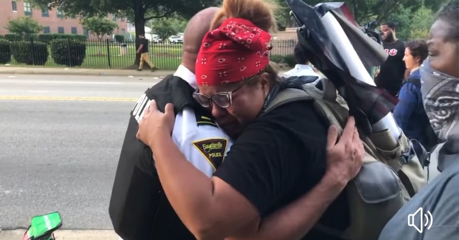 Police and Protesters Hug, Shake Hands after Officers Take a Knee in a Show of Solidarity