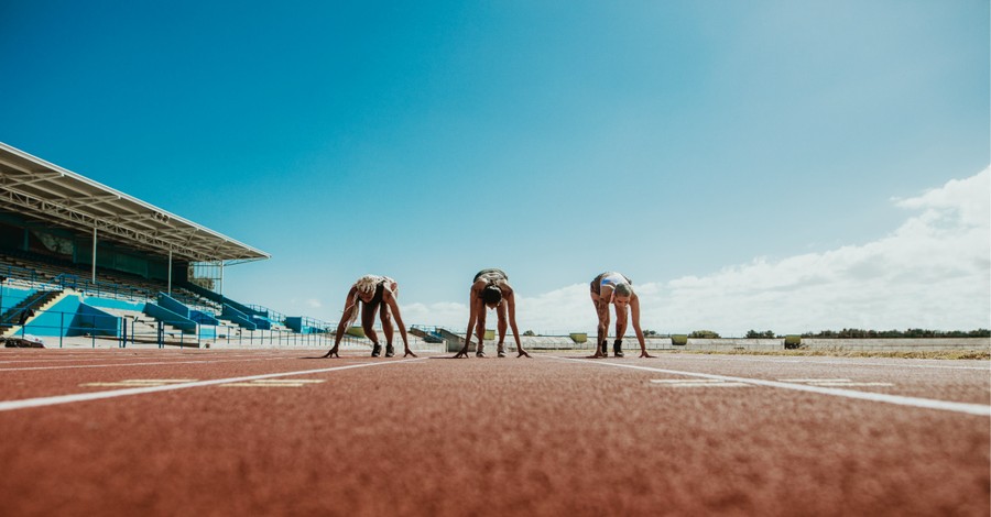 women running on a track, bill proposes schools allowing biological males athletes who identify as female to compete in sports be defunded