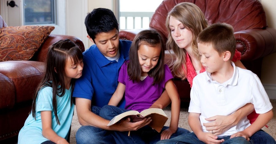family sitting together reading bible