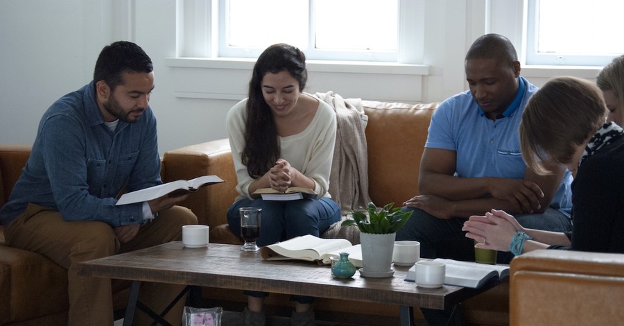 diverse Bible study sitting around coffee table