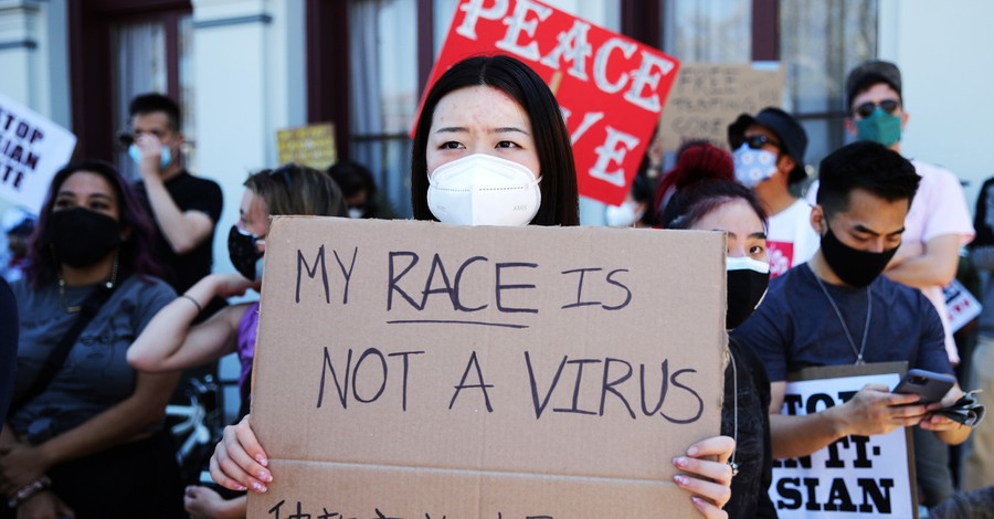 A woman holding a 'my race is not a virus' sign, Christians gather around the US to protest Anti-Asian hate