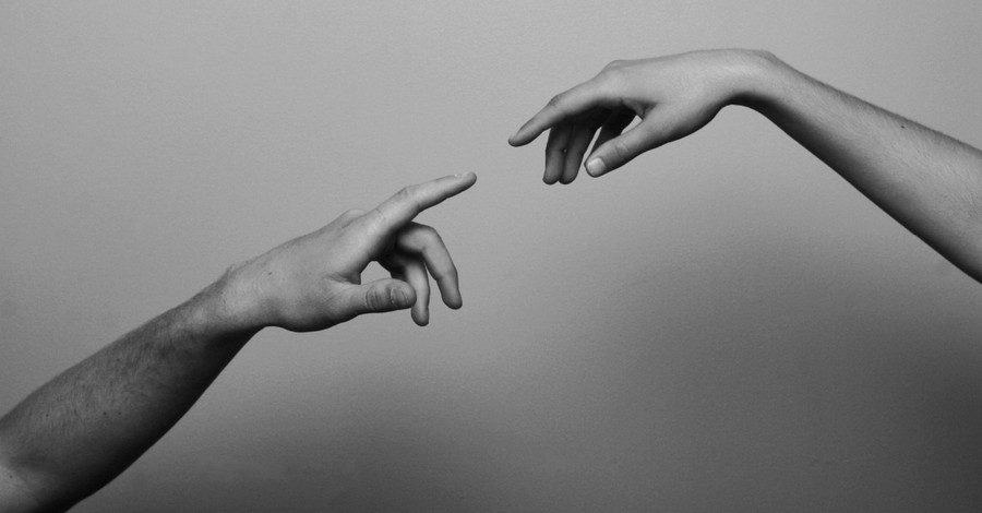hands reaching out to head other, God's image for today's world