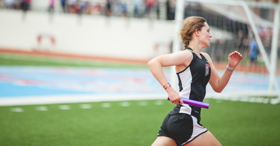 A girl running in a track event, DOE rules schools must allow transgender athletes access to bathrooms and sports corresponding to their self-identified gender