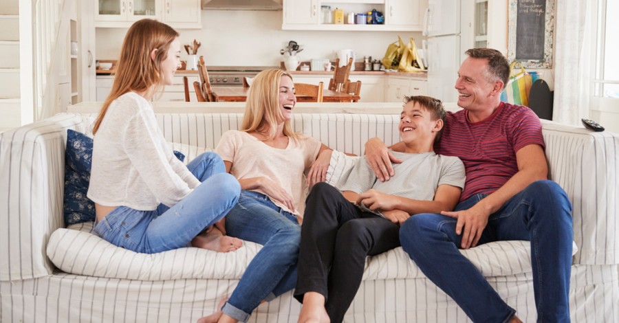 a family sitting on a couch, Conservative parents are the most successful in passing down their faith