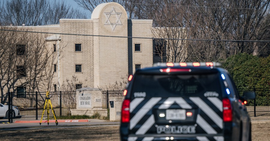 Police truck in front of a Texas Synagogue, 2 British teens arrested in the Texas synagogue hostage incident