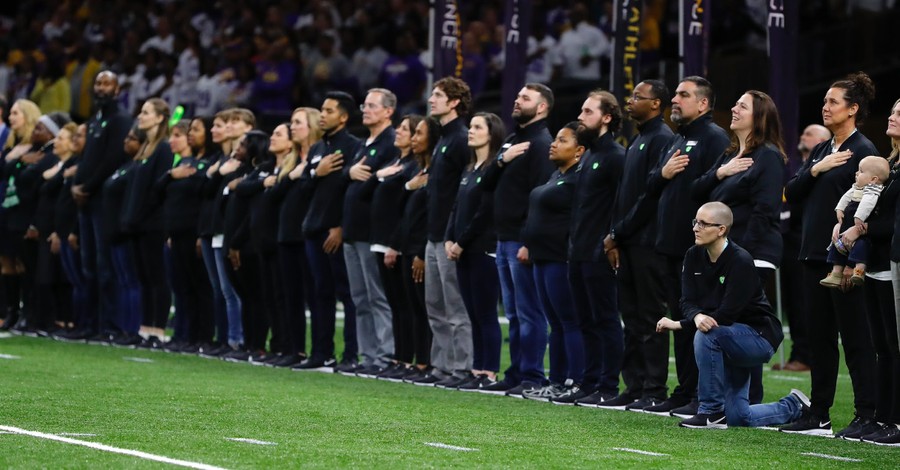 'Teacher of the Year' Kneels in Protest during National Anthem at Championship Football Game Attended By Trump