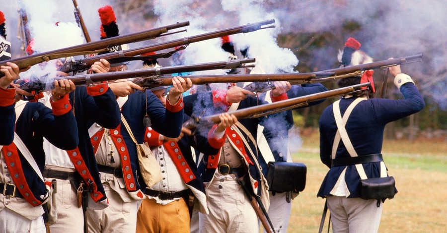 American Revolutionaries battle reenactors firing rifles