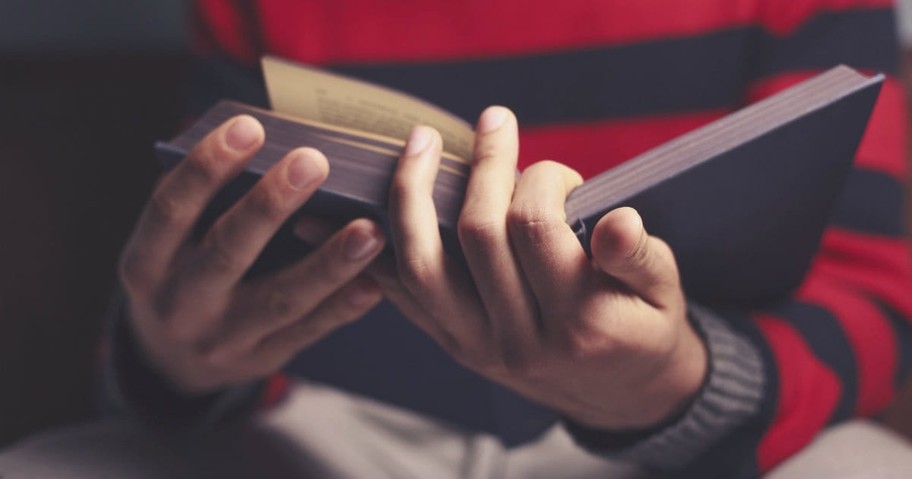 hand holding bible, lamb's book of life