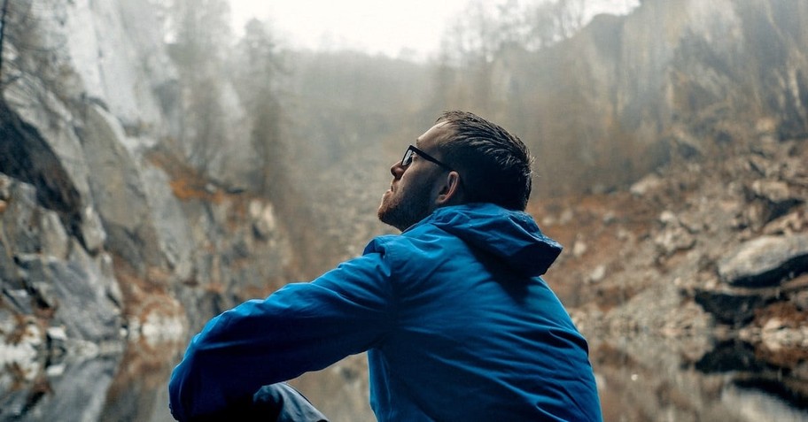 sad young man walking through forest, comforting bible verses for people experiencing grief or loss