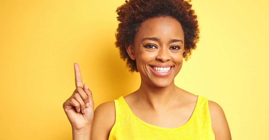 Smiling woman pointing up