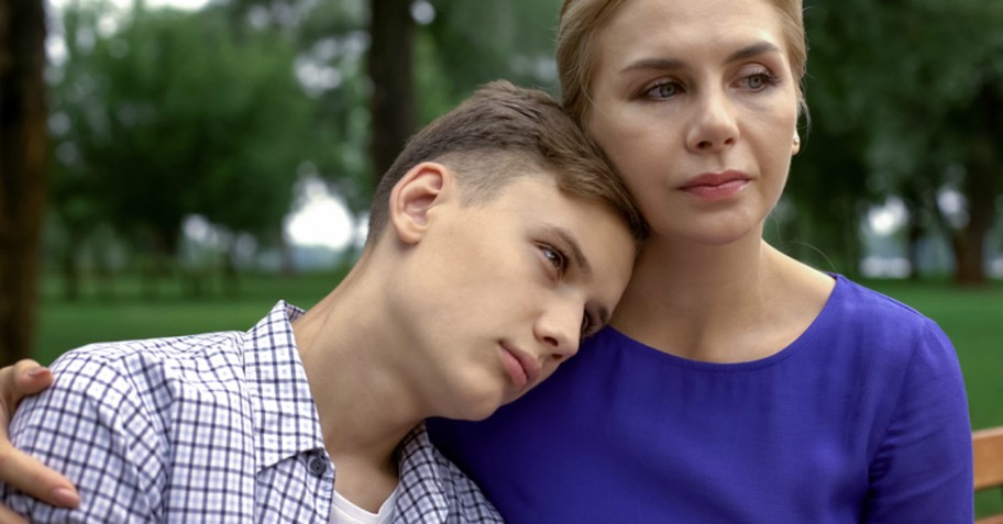 son resting head on mom shoulder