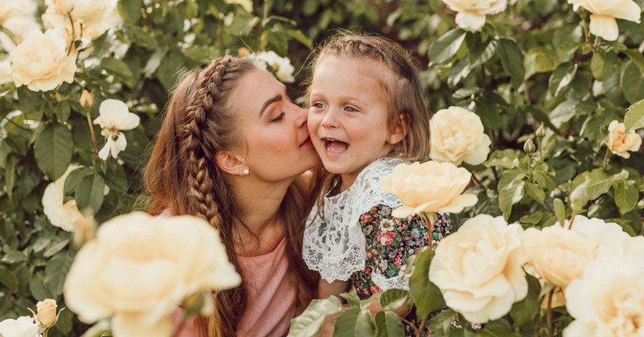 mom and daughter in flower field