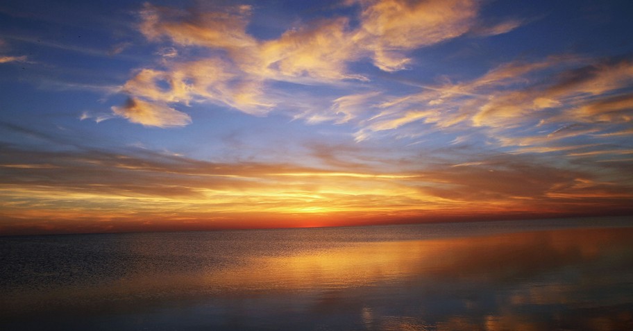 reflective sunrise over smooth waters - why did God create us