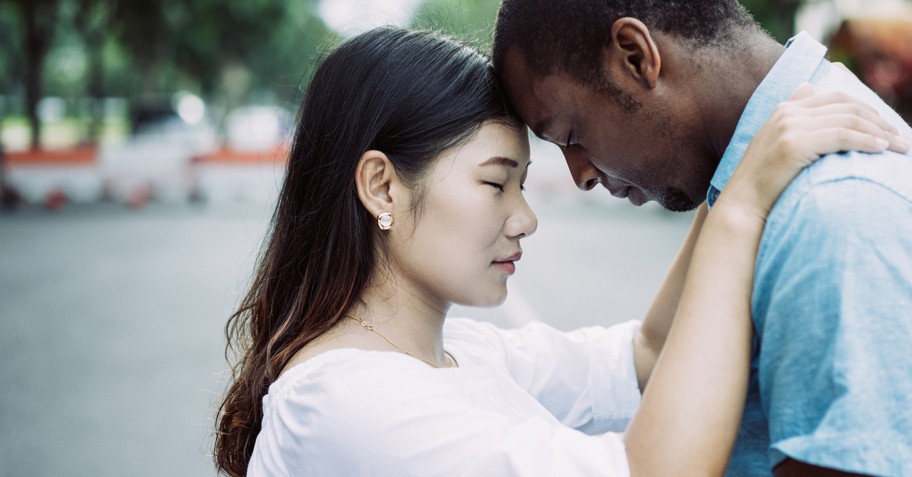 Couple hugging with their foreheads touching