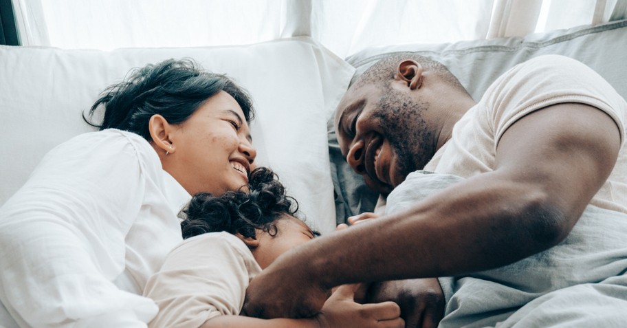 happily family relaxing in bed