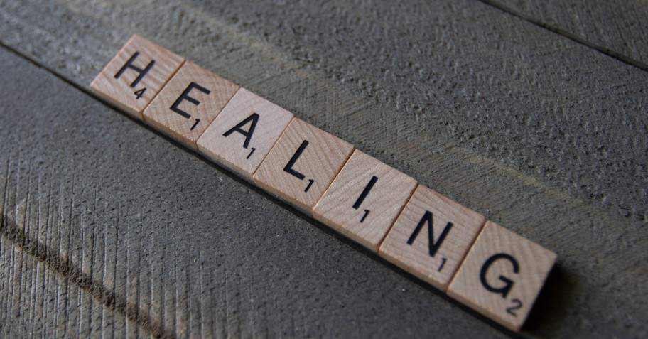 scrabble tiles spelling the word healing