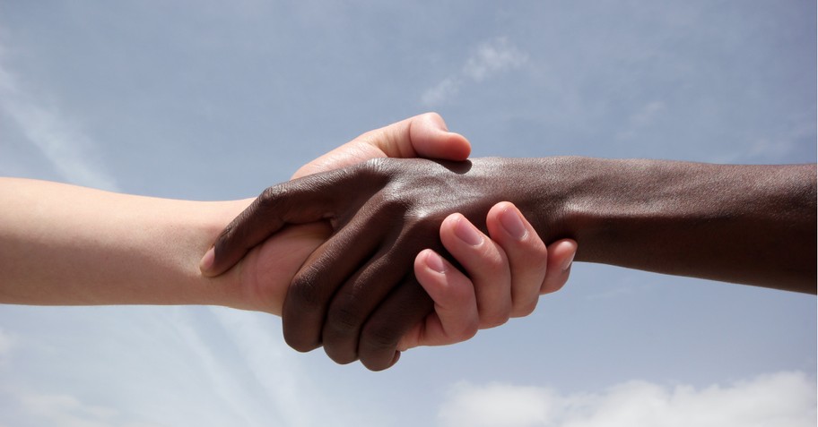 Black and White people shaking hands, The descendant of slaves and the descendant of slave owners push for racial reconciliation