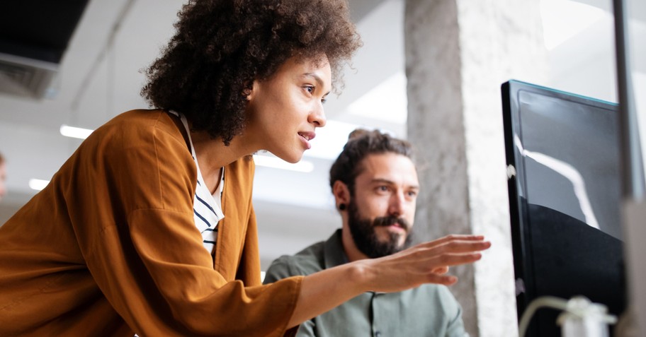 diverse woman and man working together at computer