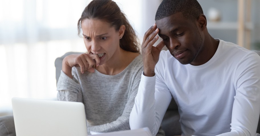 couple stressing over money anxiety at laptop