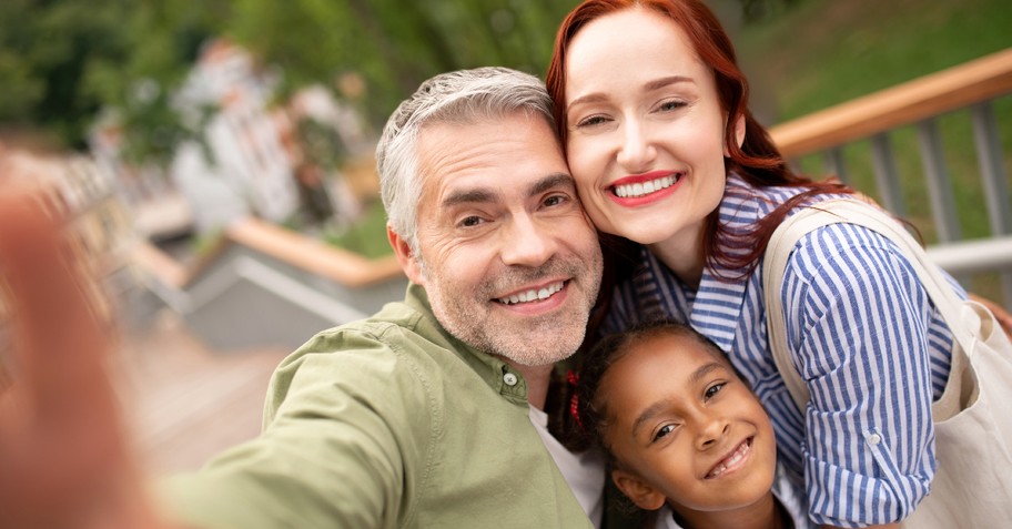 foster parents smiling with foster child