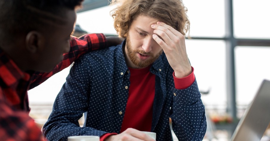 Two male friends having a serious conversation