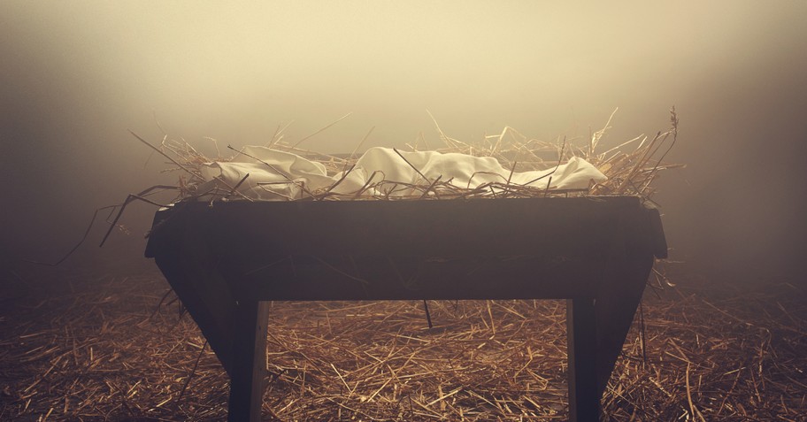 manger or creche on hay in evening fog baby Jesus Christmas