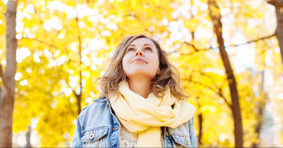 A woman surrounded by yellow leaves, love is patient love is kind