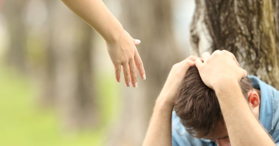 hand outstretched help up forgive forgiveness man sitting on ground