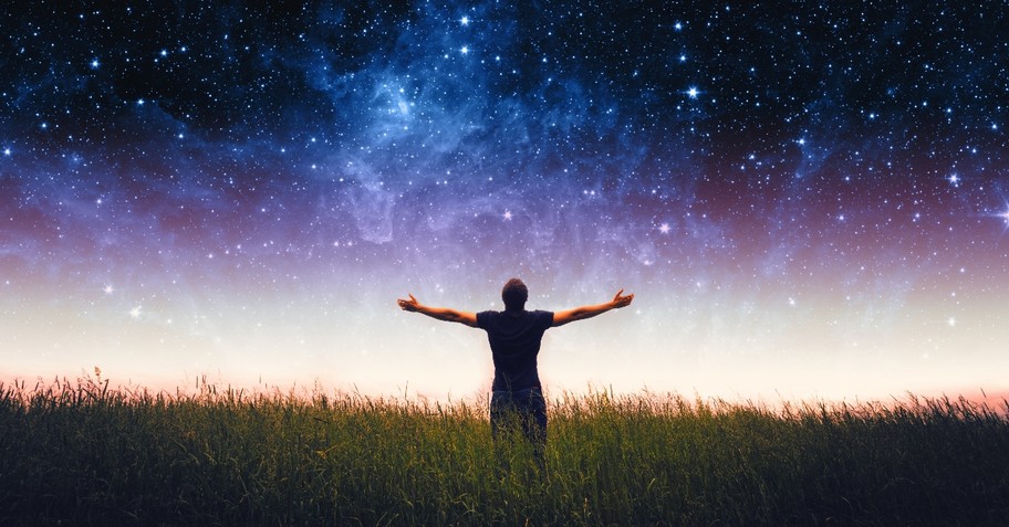 Man standing under a star-studded sky