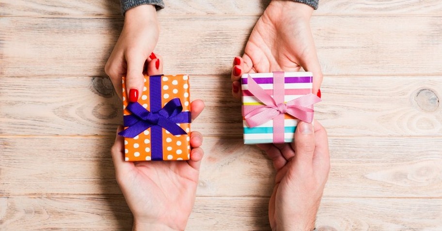 Two people exchanging small gifts