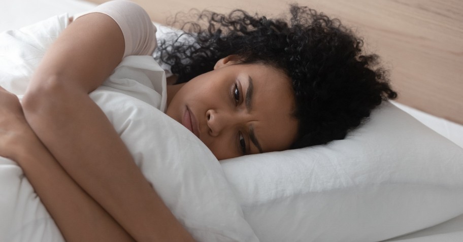 woman laying in bed looking angry and upset, never go to bed angry