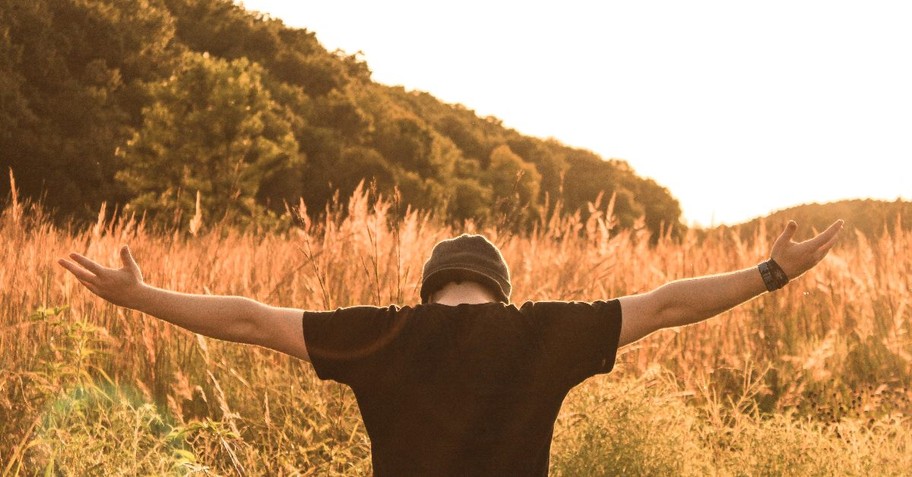 Man with his arms outstretched in prayer